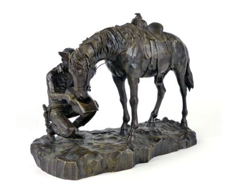 Manner of Frederick Remington, Cowboy feeding his horse from his hat, patinated bronze, length 33cm CONDITION REPORT: Some ru