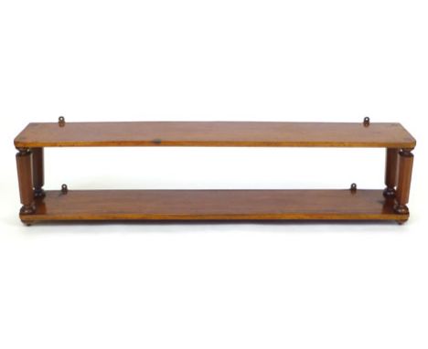 A Victorian mahogany wall hanging shelf unit with tapering octagonal supports. w. 140 cm. CONDITION REPORT: Possibly adapted 