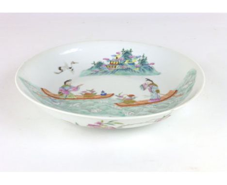 A Chinese Saucer Dish, probably 20th Century, enamelled with two ladies on rafts before mountains, flowering branches to unde
