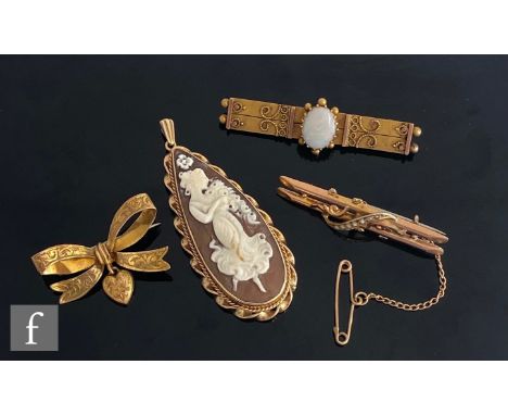 Three early 20th Century 9ct brooches to include an opal and a bow example, total weight 7.5g, with a 9ct mounted tear shaped