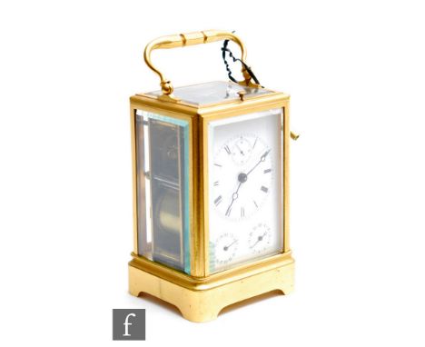 An early 20th Century French brass repeater carriage clock striking on a bell, the white enamel dial incorporating three subs