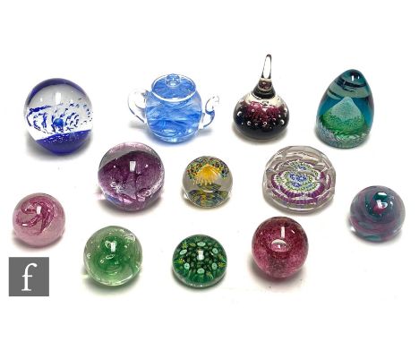 A collection of paperweights to include Caithness, Langham and Old English examples with millefiori cane works, air bubble an