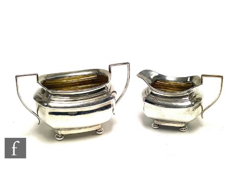 A hallmarked silver boat shaped sugar basin and cream jug of plain form each raised on four ball feet, total weight 12.5oz, B