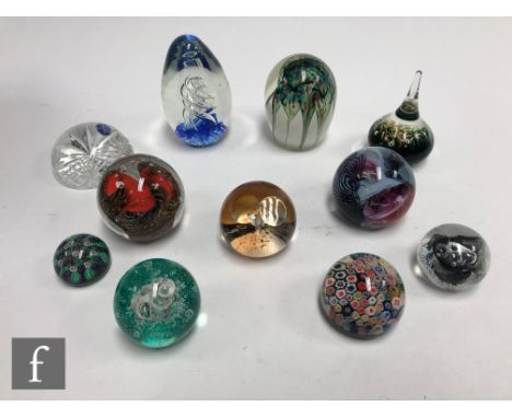 A collection of paperweights to include Caithness, Italian and Chinese examples with millefiori cane work, air bubble and swi