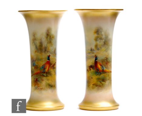 A pair of Royal Worcester shape G923 trumpet vases panel decorated by James Stinton with hand painted pheasants in a woodland