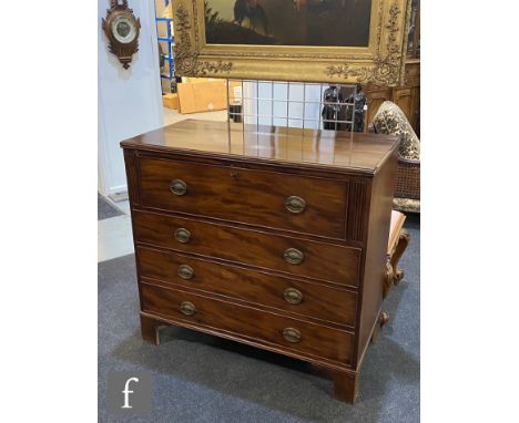 A George III style mahogany secretaire chest of four long cockbeaded drawers, the top drawer with fitted interior, oval brass