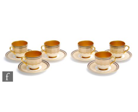 A set of six Royal Worcester coffee cans, each decorated with a gilt foliate pattern with a blue enamel border with white ena