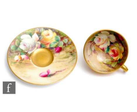 A miniature Royal Worcester cabinet cup and saucer decorated by Austin with hand painted yellow and white roses to the interi