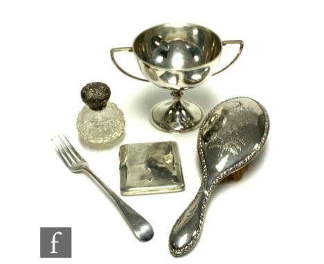 Five items of silver, a twin handled cup, a fork, a cigarette case, a hair brush and a silver topped scent bottle, total weig