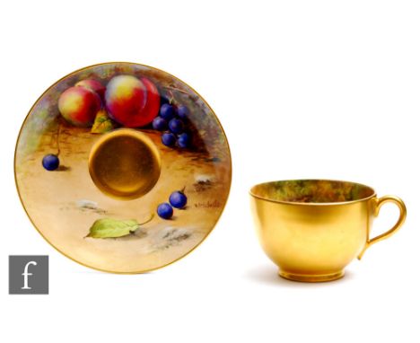 A matched Royal Worcester Fallen Fruits cabinet cup and saucer, the interior of the cup decorated with hand painted apples an