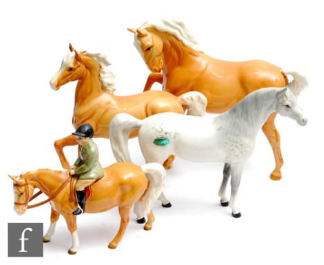 Four Beswick horses comprising a Boy on Pony model 1500, Horse with head tucked and leg up model 1549, Palomino model 1261, S