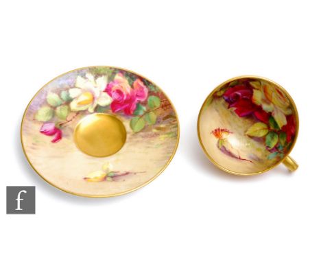 A miniature Royal Worcester cabinet cup and saucer decorated by Austin with hand painted yellow and crimson roses to the inte