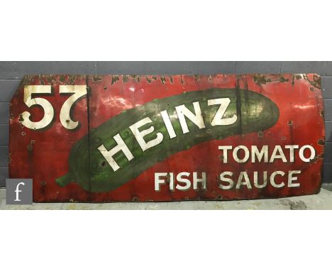 An early 20th Century enamel advertising sign '57, Heinz Tomato Fish Sauce', white lettering on a green gherkin on a red colo