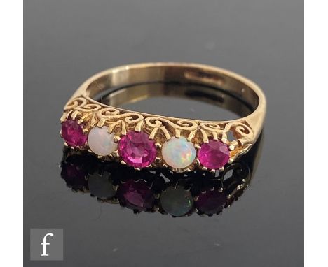 A modern 9ct hallmarked opal and ruby five stone ring, three rubies spaced by opals to a scroll head, weight 1.9g, ring size 