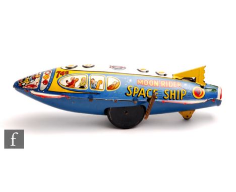 A Marx Moon Rider Space Ship tinplate toy, circa 1952, lithographed with pilots and passenger, with three wheels and yellow t
