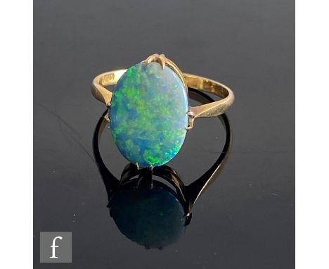 An early 20th Century 9ct opal doublet ring, oval claw set stones length 14mm, weight 2g, to knife edged shoulders, ring size