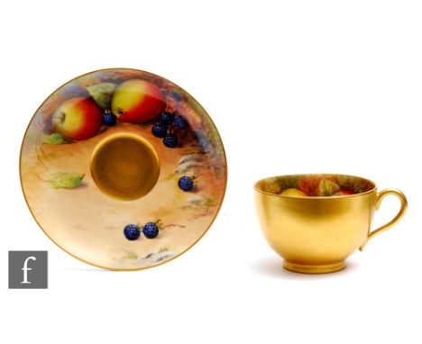 A Royal Worcester Fallen Fruits cabinet cup and saucer decorated by Austin, the interior of the cup decorated with hand paint