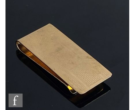 A 14ct hallmarked money clip with engine turned decoration encompassing vacant cartouche, weight 12g, length 4.5cm. 