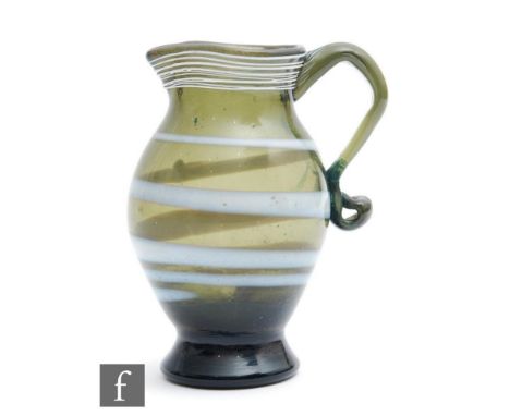 A late 18th Century jug circa 1780, of footed ovoid form with flared neck decorated with an opal enamel spiral and with appli