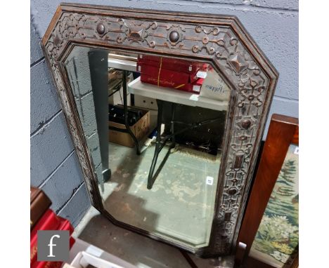 A 1920s carved oak octagonal wall mirror, 114cm x 78cm. 