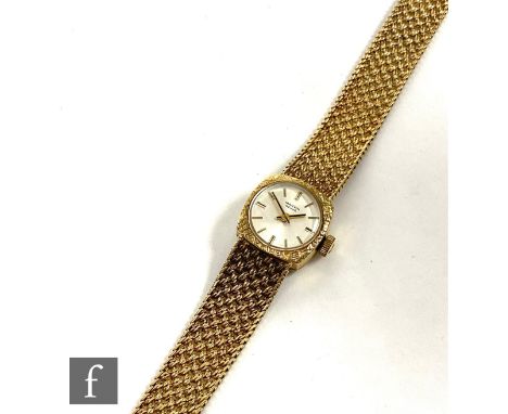 A lady's 9ct hallmarked Marvin manual wrist watch, gilt batons to a circular silvered dial and integral 9ct mesh link bracele