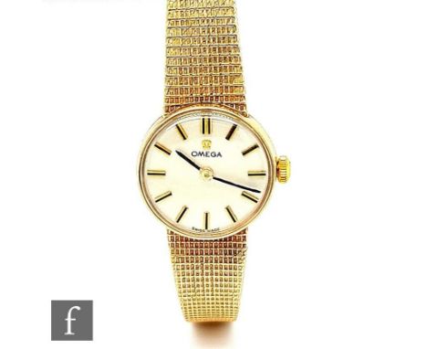 A lady's 9ct hallmarked Omega manual wind wristwatch, batons to a circular silvered dial, case diameter 20mm, total weight 20