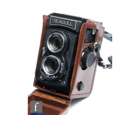 A Seagull TLR camera, serial number 03558, with original leather fitted case. 