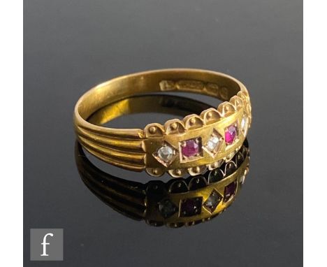 A 15ct hallmarked ruby and diamond five stone boat shaped ring, gypsy set stones to reeded shoulder, weight 2.2g, ring size N