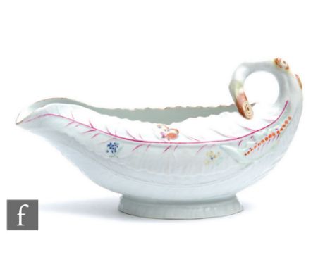 An 18th Century Worcester Cos Lettuce shape sauce boat, the moulded body sparsely decorated with hand painted flowers and a b
