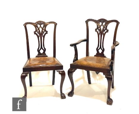 A set of six Chippendale style carved mahogany dining chairs, pierced vase splats below undulating top rail, slip in brown le