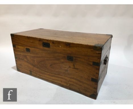 An early 20th Century brass mounted camphorwood travelling trunk, with twin wrought iron carry handles, painted 'H.J. Siggins