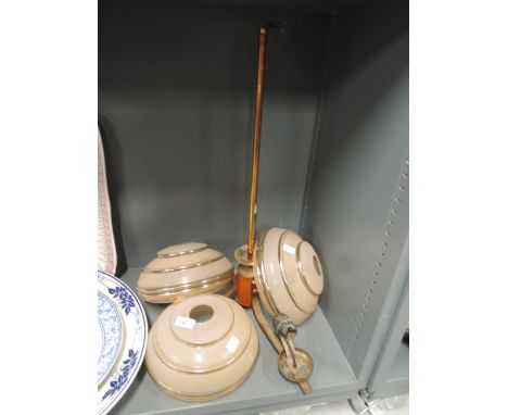 A three stem light fitting in copper brass and wood with glass shades