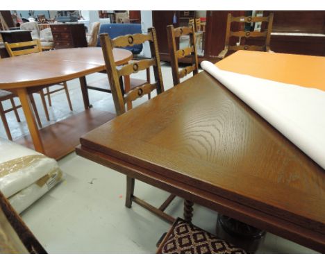 An early 20th Century oak refectory table and 7 (6 plus 1) shaped ladder back dining chairs