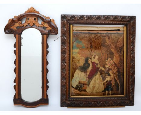 A 19th century Berlin woolwork framed tapestry, depicting an old lady being helped, in a carved beech framed together with a 