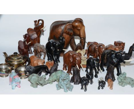 Various 20th carved ebony and hardwood elephants together with ceramic elephants.
