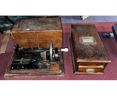An early oak cased countertop shop till, together with an early 20th century manual sewing machine. (2) 