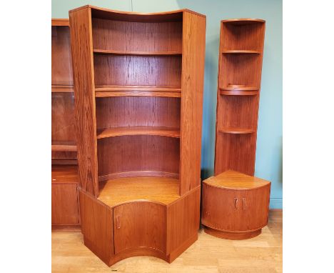 A G-Plan teak bow fronted open shelf unit with twin cupboard door below, raised on plinth base, 198cm high together with a la