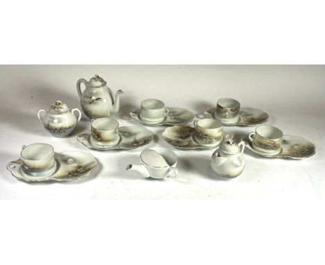 An early 20th century Japanese eggshell porcelain tea service, comprising six cup &amp; saucers, teapot, sugar pot and milk j