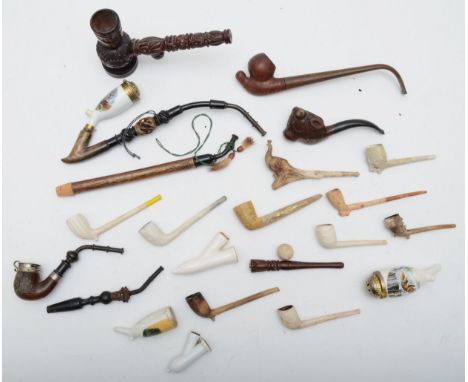 A group of tobacco pipes to include ceramic and clay examples, a caved wood pipe with hunting decoration 