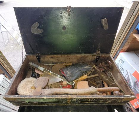 A vintage wooden tool box with various hand tools.