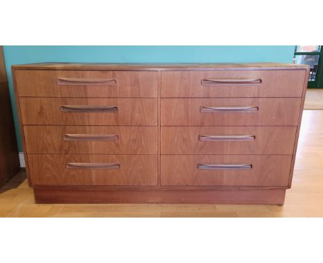 A mid 20th century G-Plan teak chest of eight drawers, raised on plinth base, 140cm wide. 