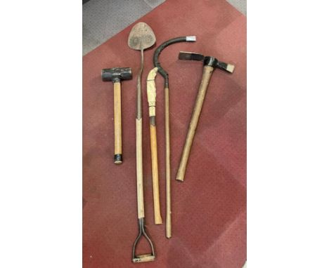 A group of vintage hand tools to include a C.T Skelton &amp; Co peat spade, a grub axe, and scythe. 