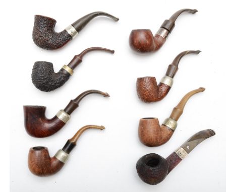 Seven Peterson Irish tobacco pipes to include two silver collared examples, and a Reject pipe. 
