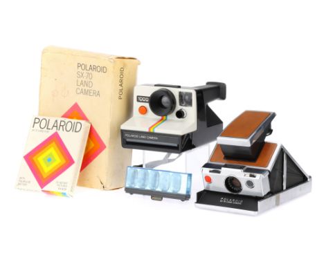 A Polaroid SX-70 Folding SLR Instant Land Camera1972-77, body VG, in maker's box and packaging, untested, with a Polaroid 100