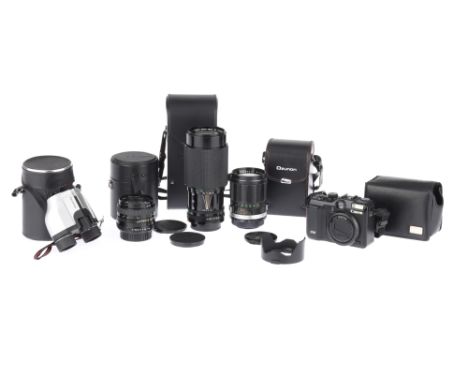 A Group of 35mm SLR Camera Lensescomprising a Canon Zoom FD New f/4 70-210mm lens with caps, a Sigma Mini-Wide II f/2.8 28mm 