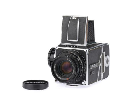 A Hasselblad 500c/m Medium Format SLR Camera,chrome, body G-VG, body shutter working, with an A12 film back, missing plastic 