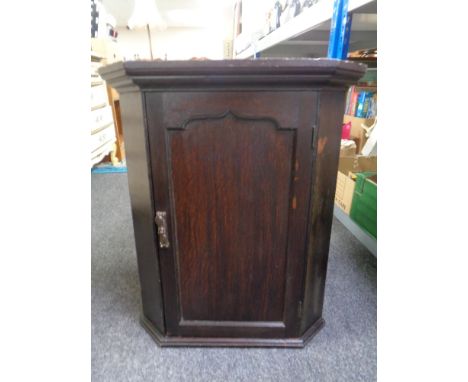 A Georgian oak panel door hanging corner cabinet 