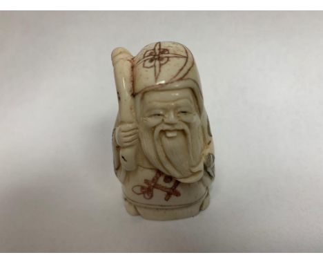 A Japanese bone carving - Bearded Old Man with Stick. 