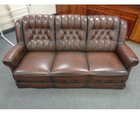 A late 20th century continental brown leather button back three seater settee 