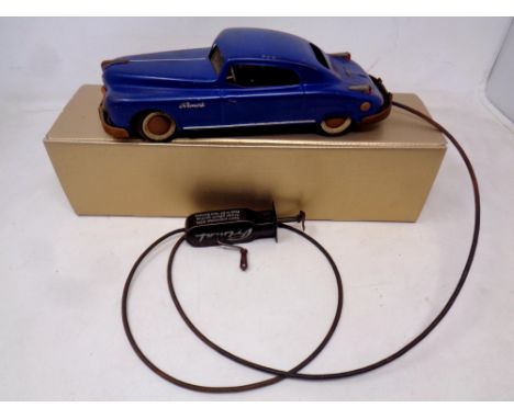 A mid 20th century Arnold tin plate Primal Coupe with manual wind remote control and cable